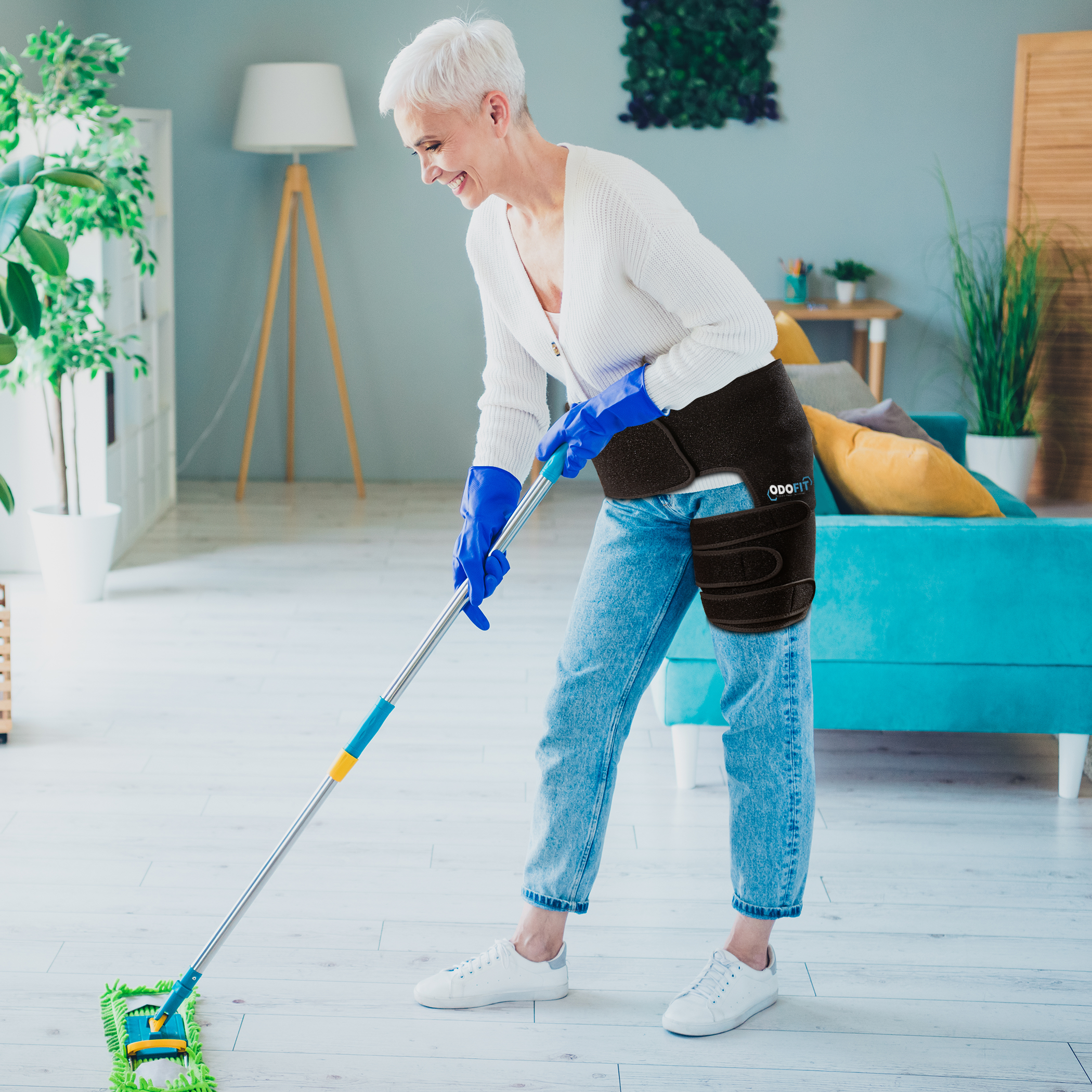 Woman wearing the ODOFIT hip brace mopping the floor